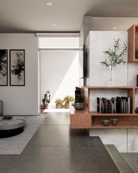 Sala de estar moderna con muebles de madera a medida, paredes de microcemento y vista al patio interior.