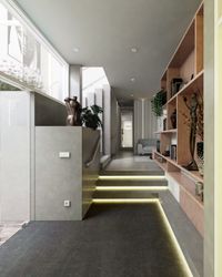 Escalera de porcelanato gris con iluminación LED integrada en peldaños y estantería de madera empotrada.